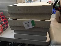 Four boxes stacked on table labeled as mixed cards, indicating bulk collection storage.