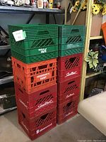 Stack of 8 milk crates showing Sealtest, Neilson, Farquhar's Dairy, and Silverwood branding.