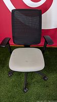 Front view of Steelcase Reply office chair showing black mesh back and alpine fabric seat with minor stains.