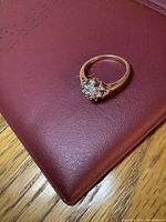 Ring viewed from above on red surface showing gemstone cluster