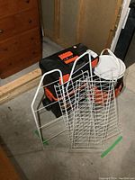 Photo showing Black & Decker toolboxes and white metal storage racks placed near lumber.