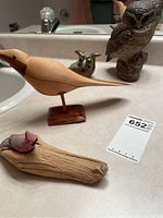Full view of all four bird figurines: two wood carved birds, two pottery owls including larger B. Linley Adams Poole owl and smaller green pottery owl.