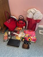 Full lot display including handbags, cosmetic bags, slippers, wallets, and grooming items.