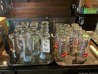 Tray of ten Blue Moon beer glasses with Blue Moon logos visible, shown upright and set close together.