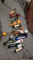 Overhead view of a cluster of assorted beer tap handles on concrete floor