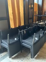 Multiple chairs stacked upside down showing frames and legs