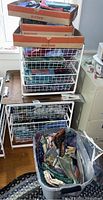 Photo showing multiple wire fabric storage bins filled with folded quilting fabrics and remnants in various colors and patterns.