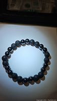 Top view of the chunky natural gemstone bracelet showing alternating lava stone and hematite beads on white background.