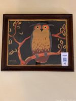 Framed acrylic print of an owl on a branch with Thomas W. Mitchell signature.