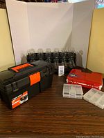 Set showing all five pieces: tool box, accessories storage rack with 24 clear containers, and three divided storage containers on a wooden surface with white backdrop.