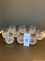 Set of ten Cristal d'Arques Longchamp lowball glasses arranged in two rows showing all items in the set, on a neutral background.