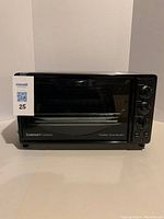 Front view of black Cuisinart Classic toaster oven broiler with glass door and control knobs on right side.