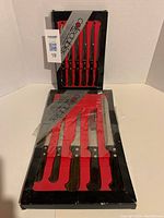 6-piece steak cutting knives set with black wooden handles, smooth blades in original black/red tray packaging