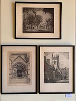 Three framed black and white etchings hung on a wall, showing detailed architectural views of University of Toronto buildings and surroundings.