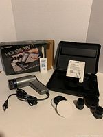 Full kit with all included parts laid out beside the original retail box and carrying case.