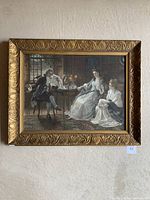 Full view of the framed print showing a family sitting for tea in an old-fashioned interior with ornate gold frame.