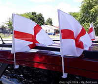 Four England car flags with Cross of St. George attached to car windows, showing size and attachment mechanism.