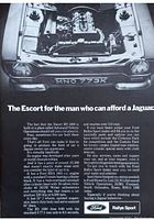 Close-up image of the vintage Ford Escort RS 1600 magazine advertisement showing the car's engine under the raised hood and the textual content describing the vehicle's performance and features.