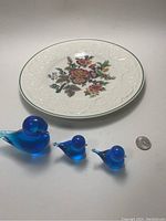 Plate shown with blue glass birds and quarter for scale.