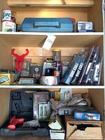 View of wooden shelves containing various car repair tools kits, accessories, packaged items, and tool cases, showing multiple rows of items including gauges, tapes, replacement parts and toolboxes.