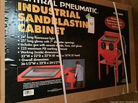 Photo of the box of Central Pneumatic Industrial Sandblasting Cabinet displaying detailed features and specifications.