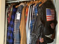 Closet rod showing entire rack of jackets, vest, denim shirt and flannels