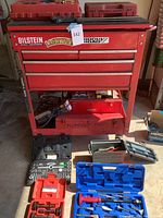 Front view of red rolling tool chest with stickers
