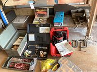 Overview of all tools on shelf including router, heater box, tire chains, toolbox, welding kit, clamps, cables, foam tape and parts organizer