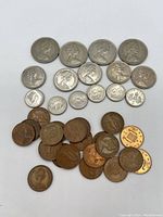 Group of 32 British coins including 6 five pence, 5 new pence, 4 ten pence, and 21 one penny coins in used condition.