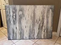 Full view of the abstract painting showcasing grey, white, and black blended colors and textured surface on canvas.