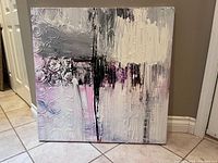 Front view of abstract artwork showing the textured paint and circular patterns.