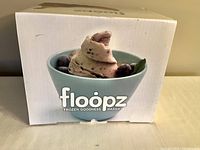 Front view of the Floopz Frozen Goodness Maker box showing the brand logo and serving suggestion of frozen dessert.