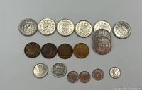 Image showing 18 Dutch coins in varied condition laid out on white background. Includes 8 One Gulden coins, 4 Five Cent coins, 2 Twenty-Five Cent coins, and 4 Ten Cent coins.