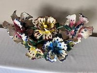 Front view of a large Capodimonte porcelain flower arrangement featuring multiple colorful, hand-painted flowers with no visible damage.