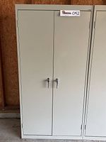 Front view of closed cabinet showing two doors and chrome locking handles