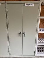 Closed cabinet front view showing two doors and handles