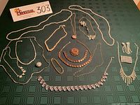 Overhead view of entire jewelry collection on green cloth
