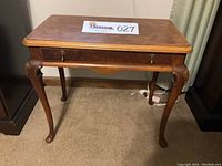 Front view of the vintage burl wood side table showing the single drawer with original hardware and cabriole legs.