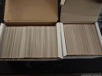 Two open boxes filled with over 400 vintage baseball trading cards, showing thickness and quantity.