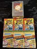 Seven unopened MLB trading card packs, including three Topps Kids packs, three Donruss Baseball puzzle and cards packs, and one sealed Nolan Ryan Texas Express collector set.