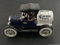 Side view of die cast 1918 Ford Model T Runabout model with Corona Extra barrel on back.
