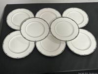 Eight Wedgwood Amherest bone china dinner plates arranged in a pattern showing the front faces.