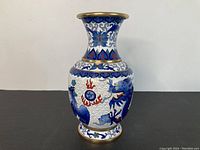 Full view of cloisonne vase showing neck and body with dragon and cloud designs