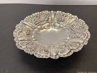 Top view showing scalloped rim and floral repoussé panels