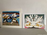 Two large unframed signed Inuit art prints side by side showing distinct scenes from Inuit culture.