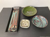 Overview of all four ceramic pieces on black background