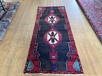 Full view of runner rug laid on floor showing geometric medallion pattern