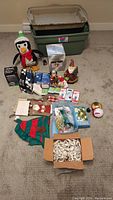 Photo showing all items of Christmas decorations and accessories including the penguin, ornaments, light boxes, and storage tote