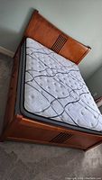 Assembled queen bed frame and mattress angled view