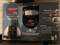 Bissell Auto Care SpotClean portable deep cleaner box showing product and features like strong spray and suction, compact design, and auto interior cleaning capabilities.